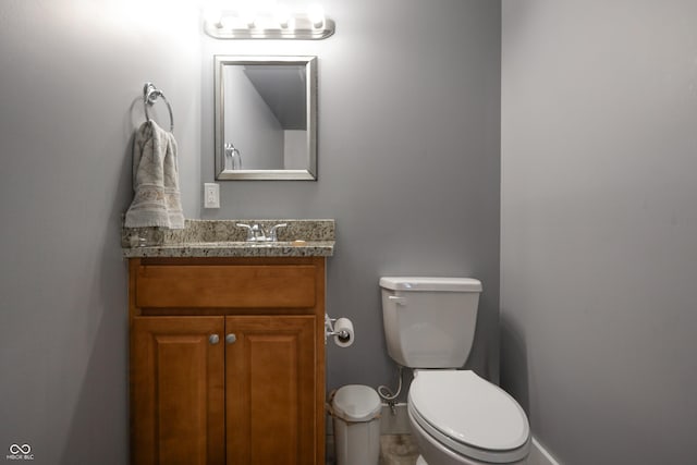 3829 Waycross Dr, Columbus, IN 47203 - half bathroom with vanity, toilet, and baseboards