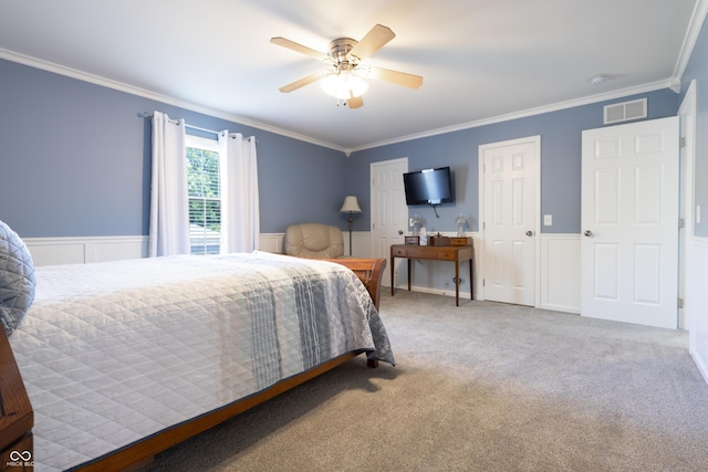 3829 Waycross Dr, Columbus, IN 47203 - carpeted bedroom featuring crown molding, a wainscoted wall, ceiling fan, and multiple closets