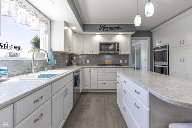 3829 Waycross Dr, Columbus, IN 47203 - kitchen featuring a sink, stainless steel appliances, white cabinetry, decorative backsplash, and dark wood-type flooring