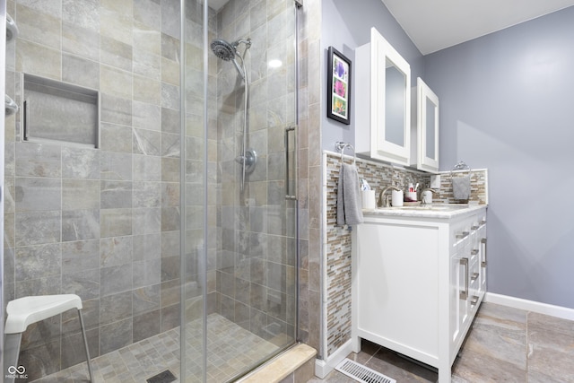 3829 Waycross Dr, Columbus, IN 47203 - bathroom with a stall shower, baseboards, vanity, and backsplash