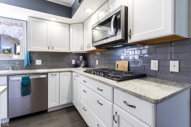 3829 Waycross Dr, Columbus, IN 47203 - kitchen with stainless steel appliances, tasteful backsplash, white cabinets, dark wood-style flooring, and light stone counters