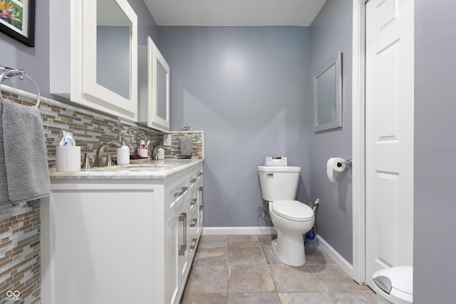 3829 Waycross Dr, Columbus, IN 47203 - bathroom with toilet, tasteful backsplash, baseboards, and vanity