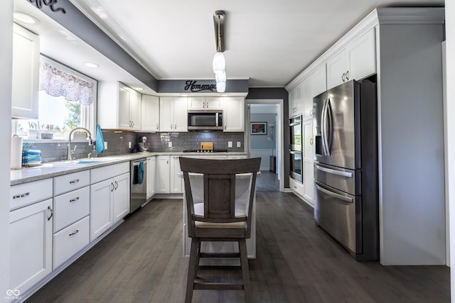 3829 Waycross Dr, Columbus, IN 47203 - kitchen with appliances with stainless steel finishes, a sink, white cabinetry, decorative backsplash, and dark wood-type flooring