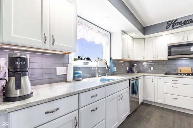 3829 Waycross Dr, Columbus, IN 47203 - kitchen featuring a sink, appliances with stainless steel finishes, white cabinetry, and backsplash
