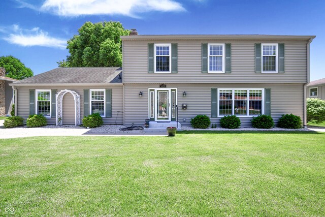3829 Waycross Dr, Columbus, IN 47203 - colonial house featuring a front yard and a chimney