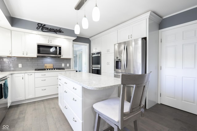 3829 Waycross Dr, Columbus, IN 47203 - kitchen with stainless steel appliances, ornamental molding, wood finished floors, backsplash, and white cabinetry