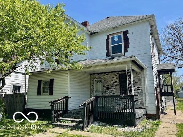 2701 N Gale St, Indianapolis, IN 46218 - view of front of house featuring covered porch, fence, and a shingled roof