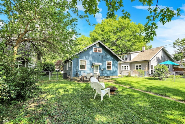 back of property with a fire pit