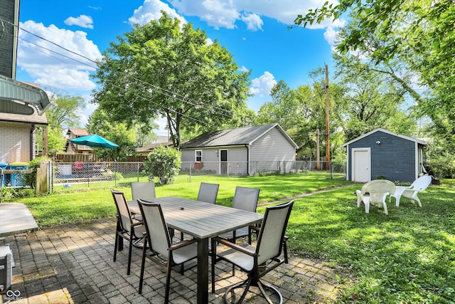 view of patio featuring outdoor dining area, a storage unit, and an outdoor structure