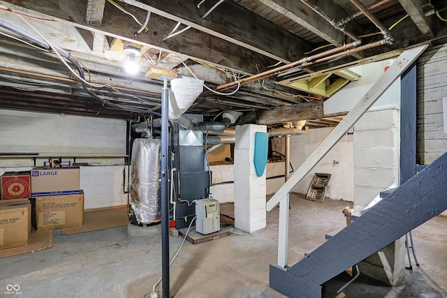 unfinished below grade area featuring heating unit