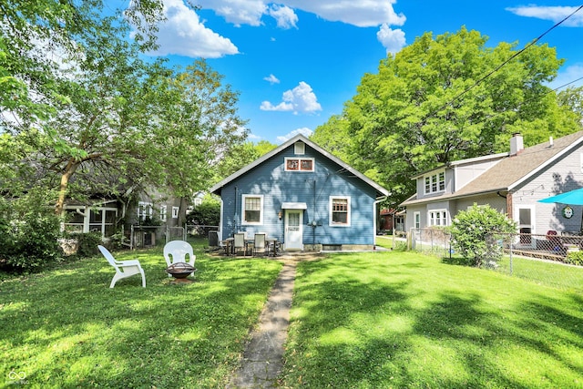 rear view of house featuring a fire pit