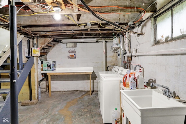 basement featuring a sink and washer and dryer