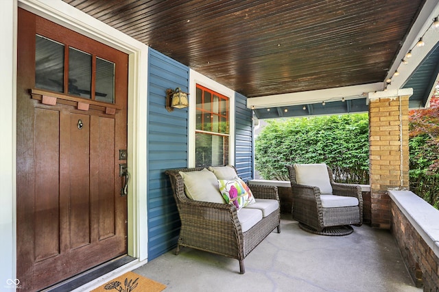 view of exterior entry featuring covered porch