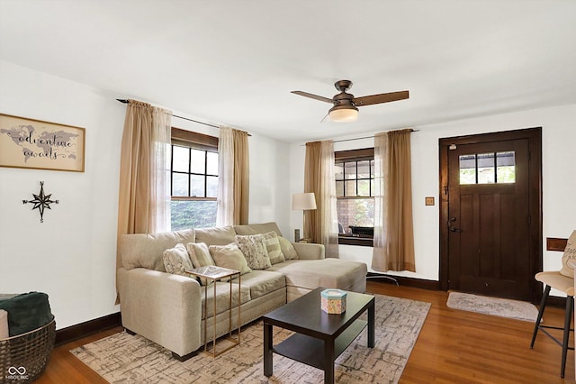 living area with wood finished floors, ceiling fan, and baseboards