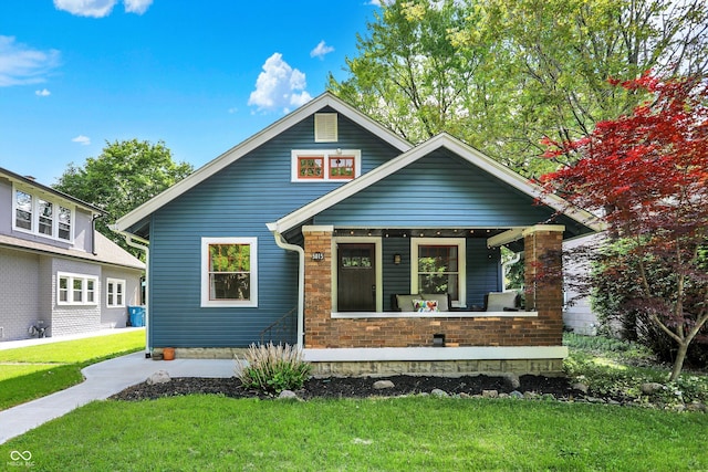 view of front of home featuring covered porch and a front yard