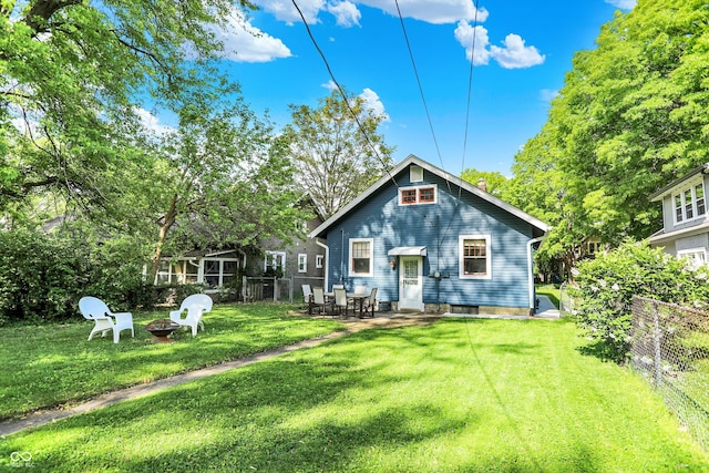 back of house featuring a fire pit