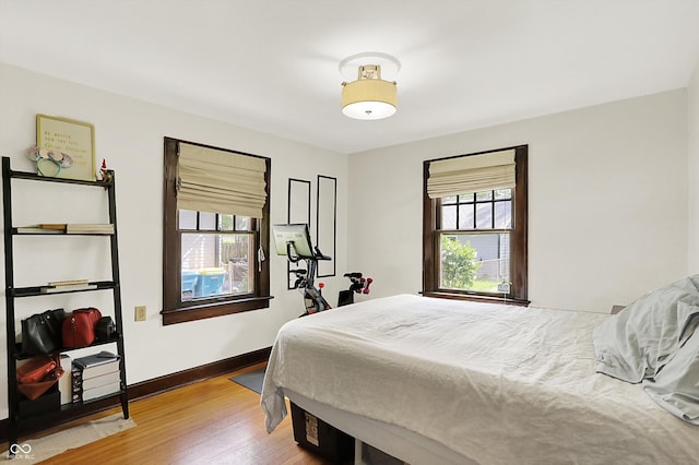 bedroom featuring wood finished floors and baseboards