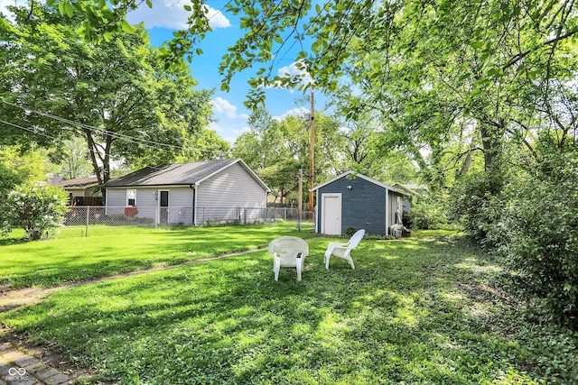 view of yard featuring an outdoor structure and view of scattered trees