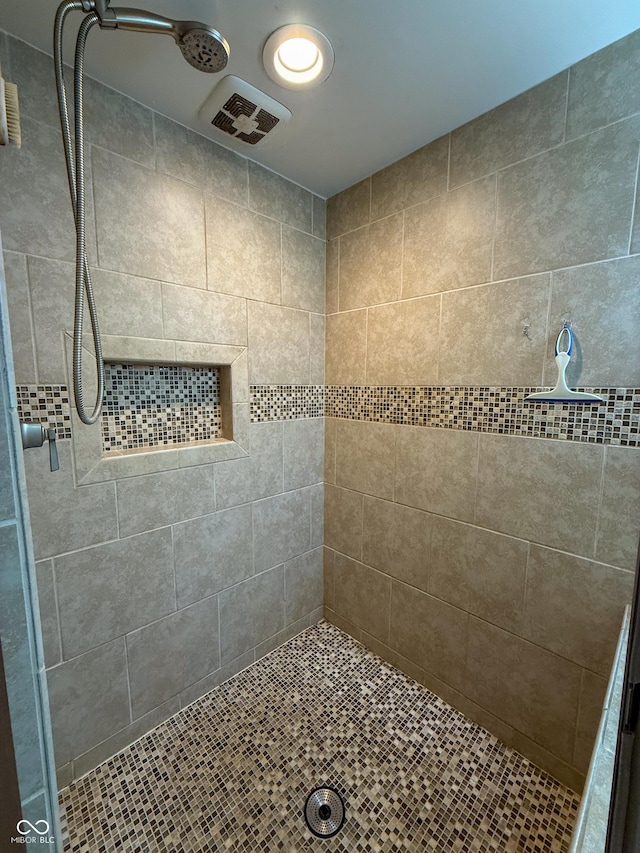 bathroom with tiled shower