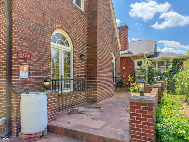 doorway to property featuring brick siding