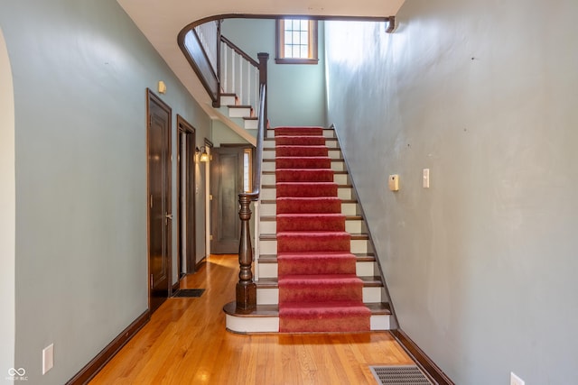 stairs featuring wood finished floors