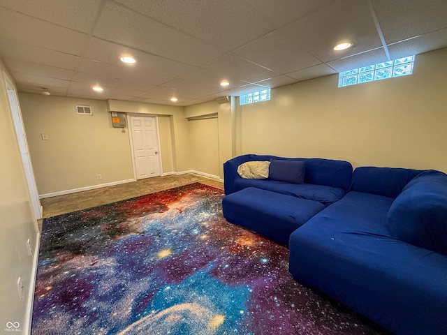 carpeted living area with a drop ceiling and recessed lighting