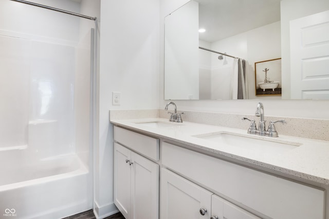 bathroom featuring double vanity, a sink, and shower / bathtub combination with curtain