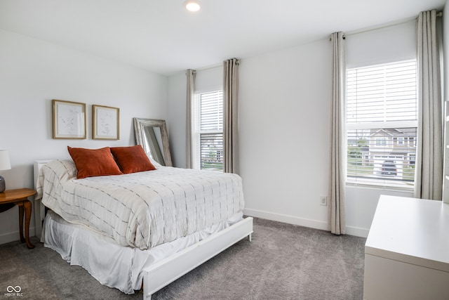 carpeted bedroom with baseboards, multiple windows, and recessed lighting