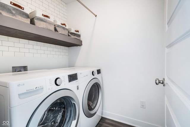 laundry room featuring separate washer and dryer, laundry area, dark wood-type flooring, and baseboards