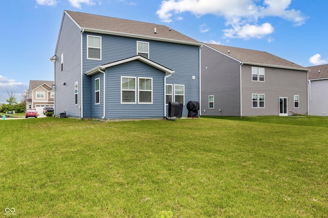 rear view of house featuring a yard