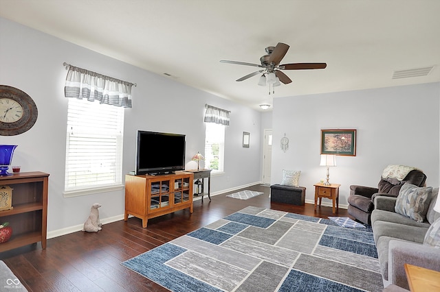 living room with hardwood / wood-style flooring, a ceiling fan, and baseboards