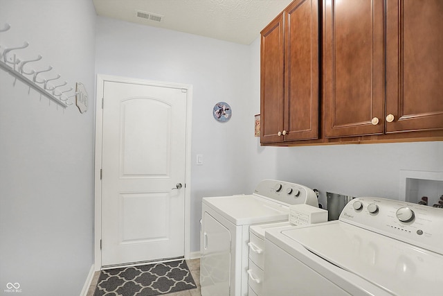 laundry area featuring cabinet space, separate washer and dryer, and baseboards
