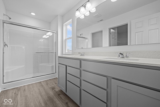 6219 Medina Spirit Dr, Indianapolis, IN 46237 - full bathroom with a shower stall, double vanity, and wood finished floors