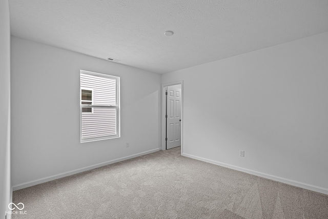 6219 Medina Spirit Dr, Indianapolis, IN 46237 - carpeted empty room featuring baseboards and a textured ceiling