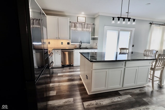 kitchen featuring dishwasher, a sink, ornamental molding, backsplash, and white cabinets