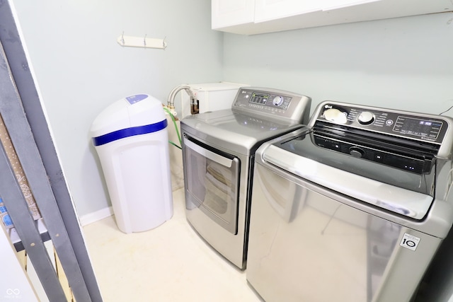 laundry room featuring washer and clothes dryer and cabinet space