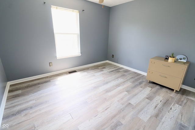 empty room featuring light wood-style flooring and baseboards