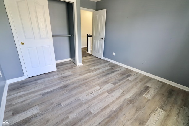 unfurnished bedroom featuring wood finished floors and baseboards