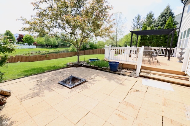 view of patio with a fire pit, a deck with water view, and a pergola