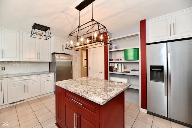 10713 Stable Dr, Indianapolis, IN 46239 - kitchen featuring stainless steel fridge, a chandelier, light tile patterned flooring, and white cabinets