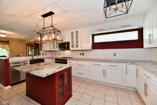 10713 Stable Dr, Indianapolis, IN 46239 - kitchen featuring a chandelier, appliances with stainless steel finishes, light tile patterned flooring, and tasteful backsplash
