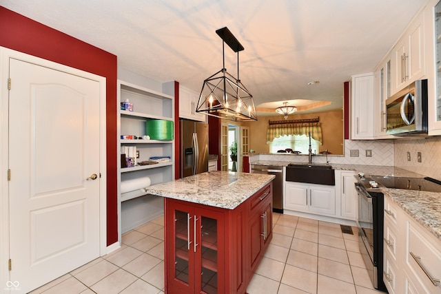 10713 Stable Dr, Indianapolis, IN 46239 - kitchen featuring appliances with stainless steel finishes, a sink, light tile patterned flooring, and white cabinets