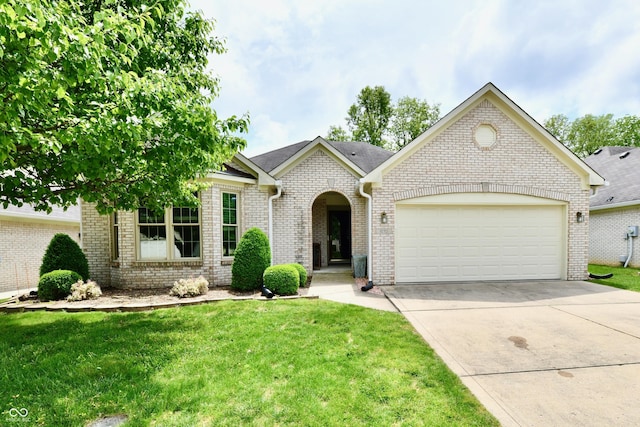 10713 Stable Dr, Indianapolis, IN 46239 - view of front of home featuring a garage, brick siding, a front lawn, and driveway
