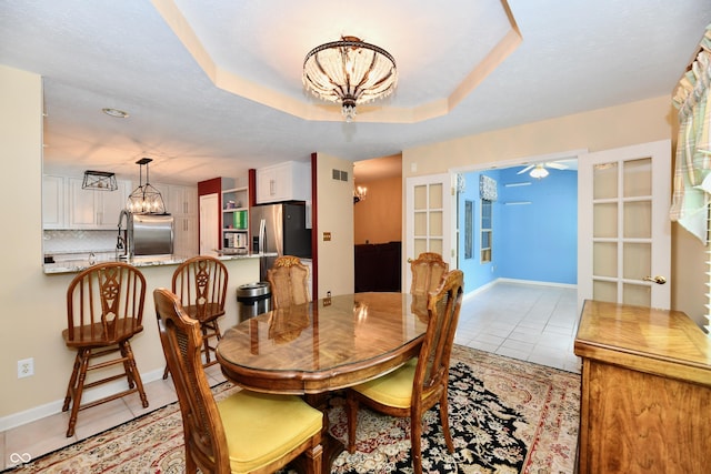 10713 Stable Dr, Indianapolis, IN 46239 - dining space with a chandelier, light tile patterned flooring, ceiling fan, and baseboards
