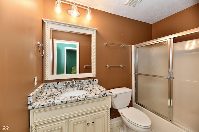 10713 Stable Dr, Indianapolis, IN 46239 - bathroom featuring toilet, vanity, combined bath / shower with glass door, and baseboards