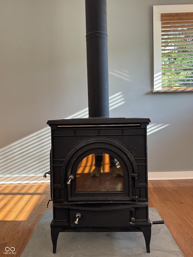 7897 Moore Rd, Indianapolis, IN 46278 - detailed view of a wood stove, baseboards, and wood finished floors