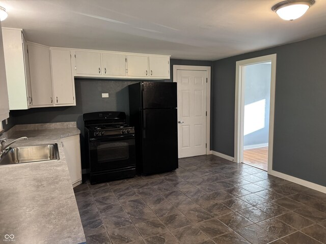 7897 Moore Rd, Indianapolis, IN 46278 - kitchen with black appliances, a sink, baseboards, dark stone finish floors, and white cabinets