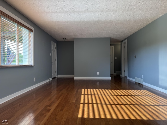 7897 Moore Rd, Indianapolis, IN 46278 - empty room with wood finished floors, a textured ceiling, and baseboards