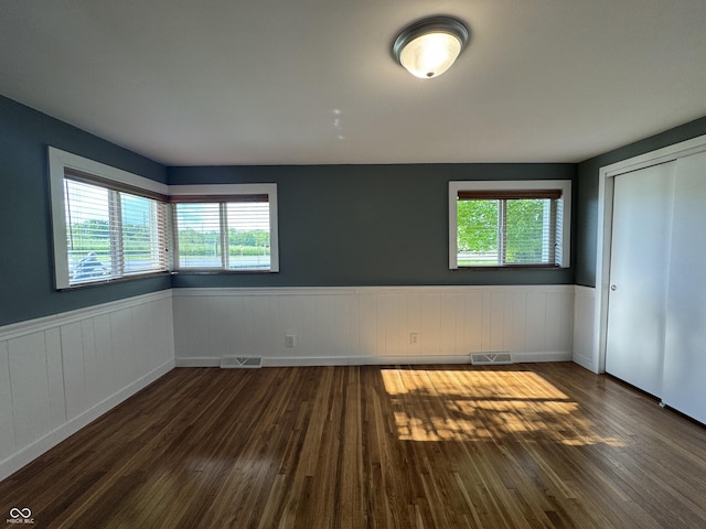 7897 Moore Rd, Indianapolis, IN 46278 - unfurnished bedroom featuring wainscoting, dark wood finished floors, and a closet