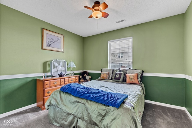 carpeted bedroom with baseboards, a ceiling fan, and a textured ceiling